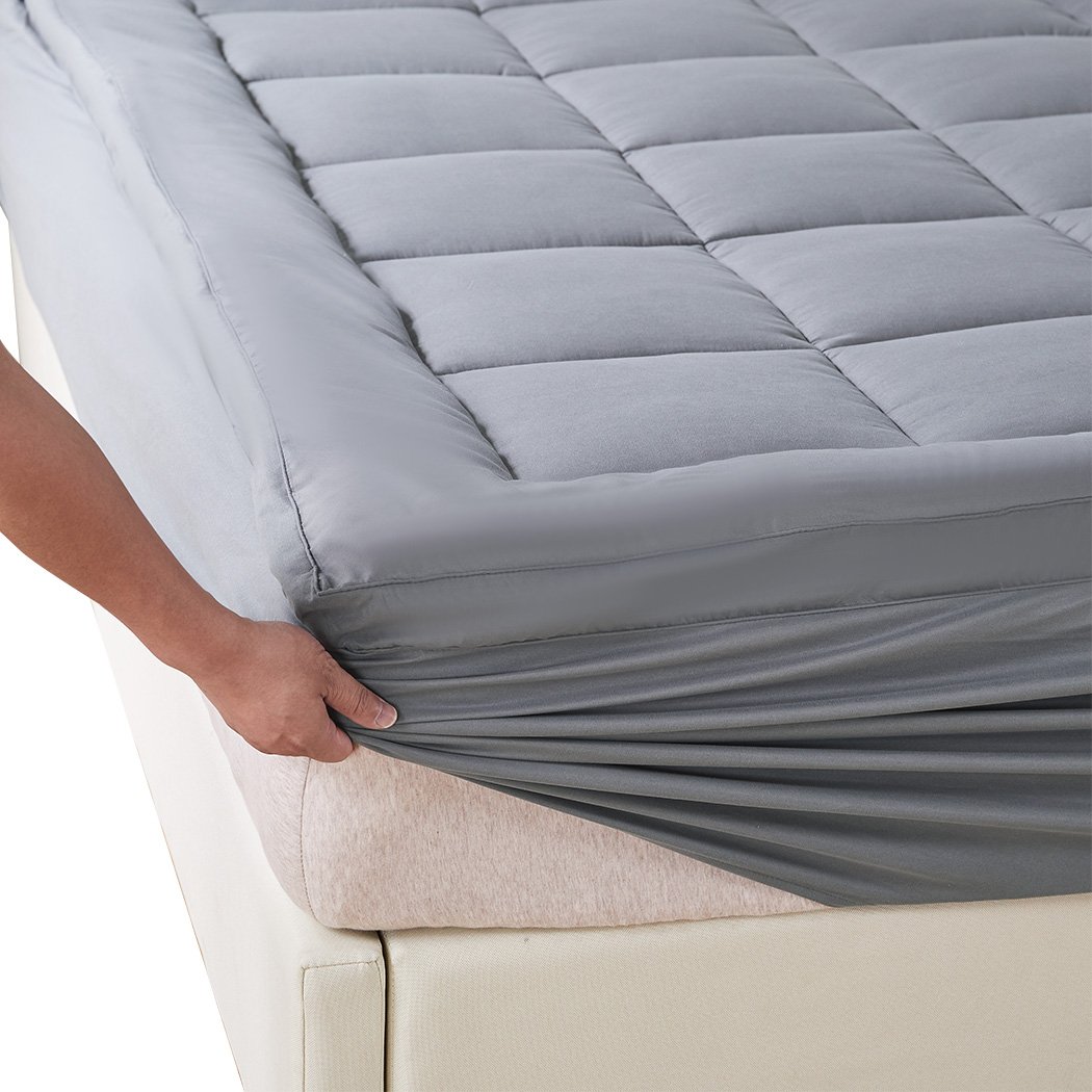 Dreamz Mattress Topper made of bamboo fibre with a luxurious pillowtop design, featuring a charcoal color and fully-fitted elastic skirt.