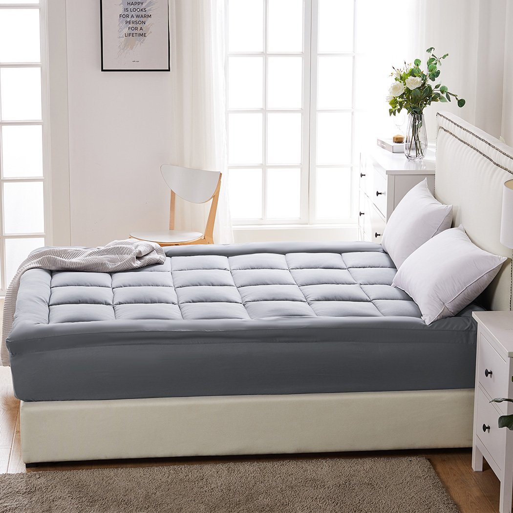 Dreamz Mattress Topper made of bamboo fibre with a plush pillowtop design, featuring a charcoal color and elastic skirt for a secure fit.