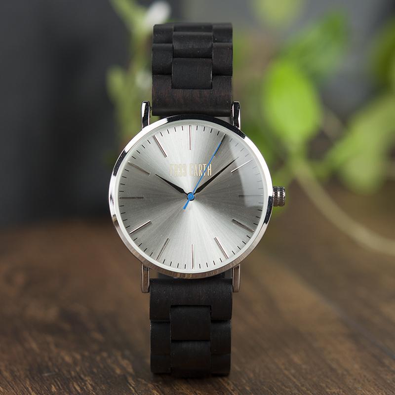 Evening Watch featuring a stainless steel case and a unique wooden band, showcasing its stylish design suitable for both men and women.