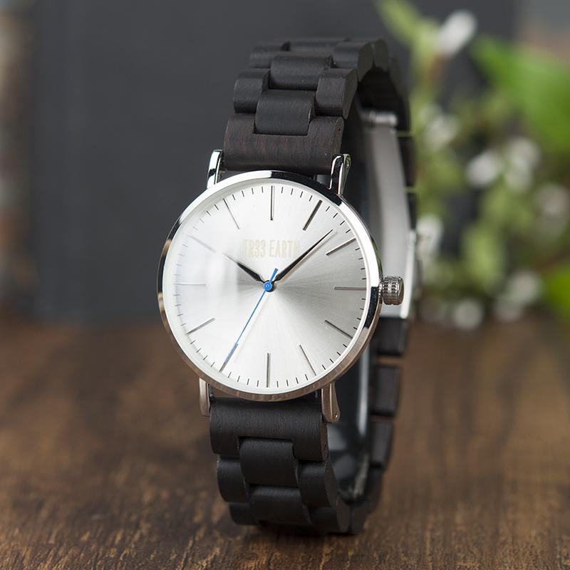 Evening Watch featuring a stainless steel case and a unique wooden band, showcasing its stylish design suitable for both men and women.