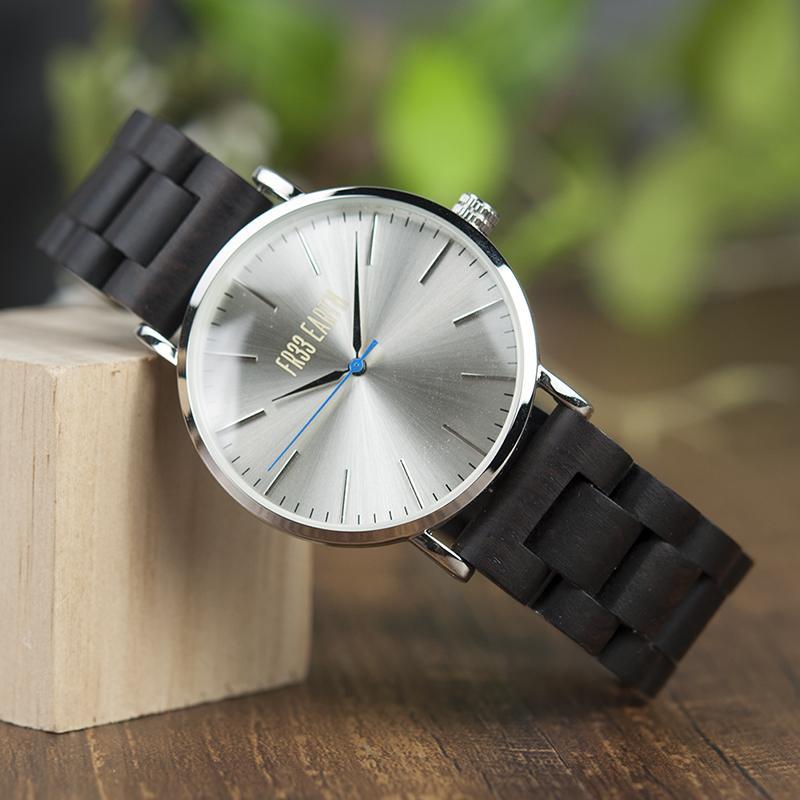 Evening Watch featuring a stainless steel case and a unique wooden band, showcasing its stylish design suitable for both men and women.