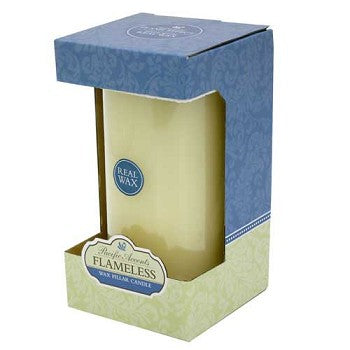 Flameless 4 x 8 Flat Top Wax Pillar Candle in a cozy indoor setting, showcasing its elegant design and warm glow.