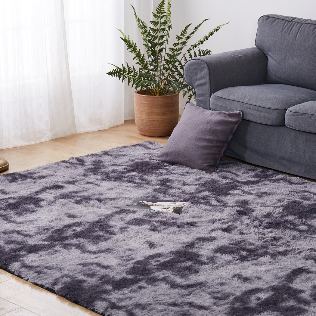 A large tie-dyed shaggy rug in midnight colors, showcasing a soft 35mm high pile and a non-slip silicone bottom, perfect for home decor.