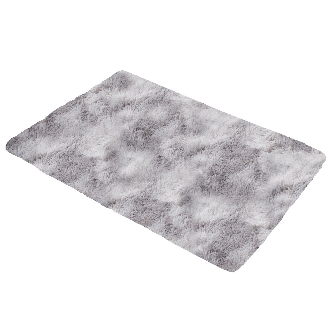 A large tie-dyed shaggy rug measuring 160x230cm, featuring a soft plush surface and a non-slip silicone bottom, perfect for home decor.