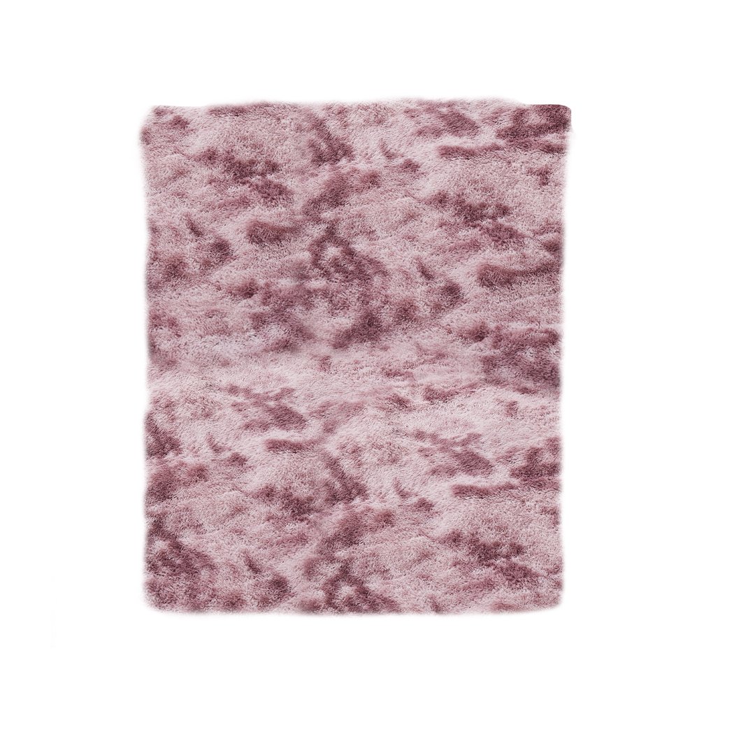 A large, soft shaggy floor rug with a vibrant tie-dyed pattern, showcasing its plush texture and non-slip silicone bottom.