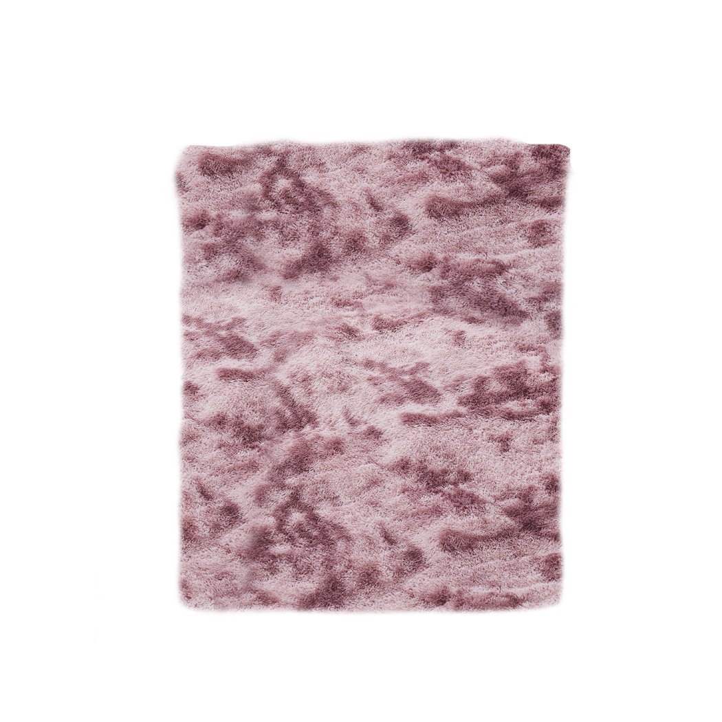 A large, soft shaggy floor rug with a vibrant tie-dyed pattern, showcasing its plush texture and non-slip silicone bottom.