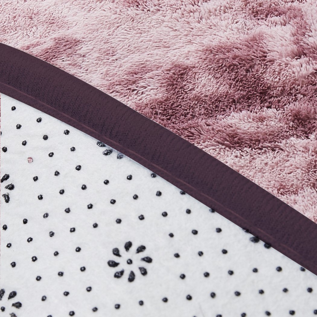 A large, soft shaggy floor rug with a vibrant tie-dyed pattern, showcasing its plush texture and non-slip silicone bottom.