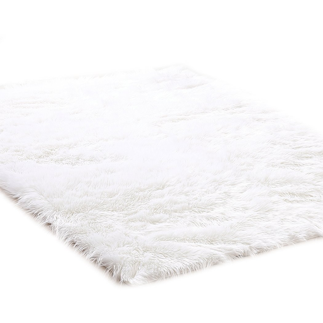 Luxurious white sheepskin shaggy rug with a plush texture, perfect for enhancing home decor in living rooms and bedrooms.