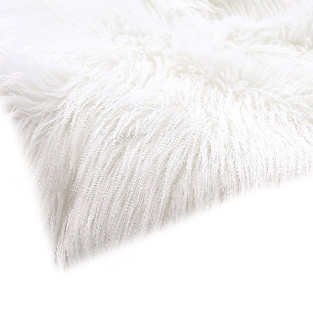 Luxurious white sheepskin shaggy rug with a plush 60-70mm pile, perfect for living rooms and bedrooms.