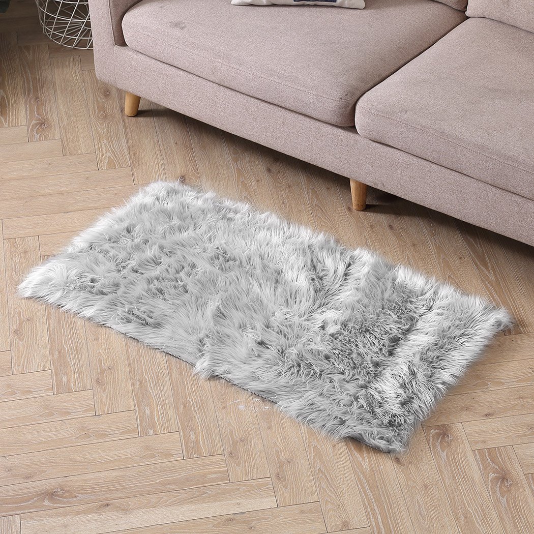 Luxurious grey sheepskin shaggy rug with a plush 60-70mm pile, perfect for living rooms and bedrooms.