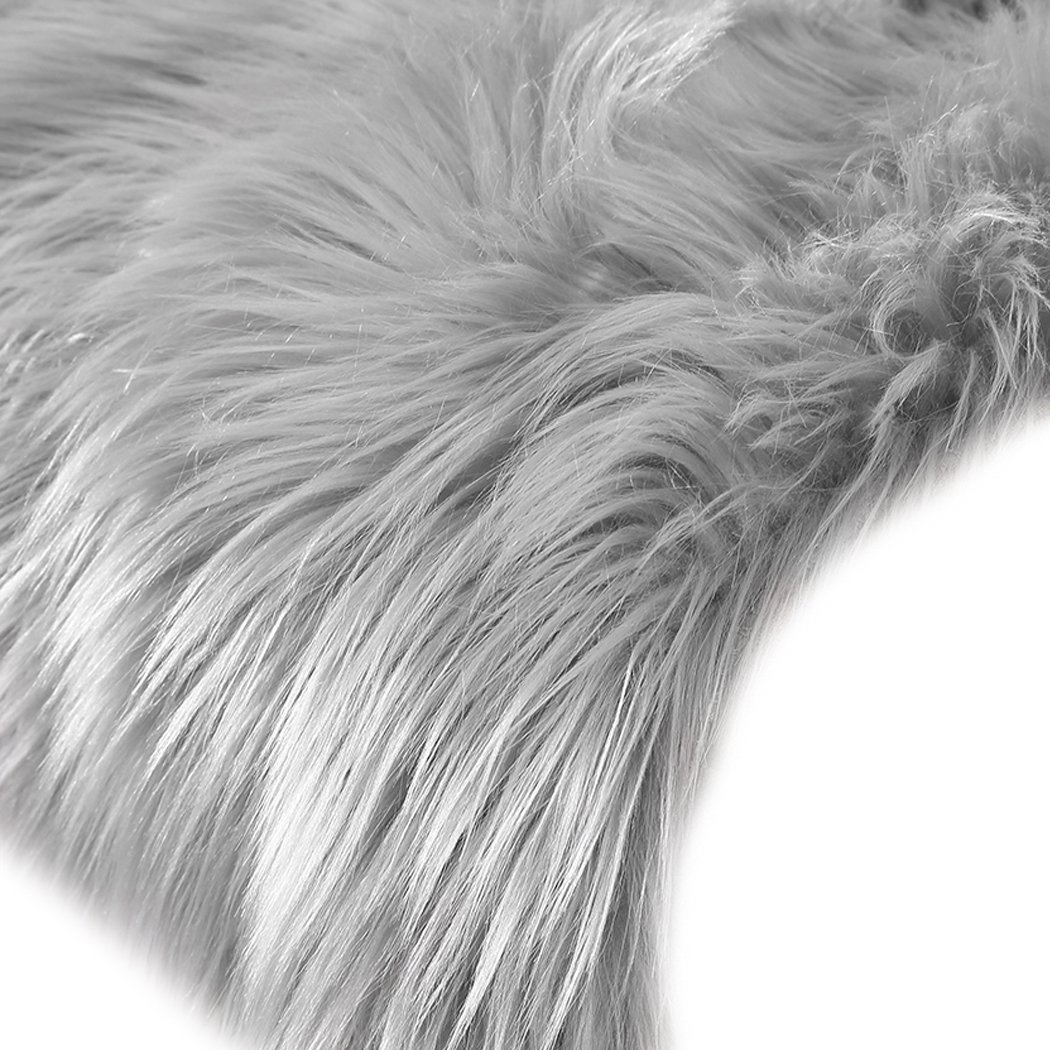 Luxurious grey sheepskin shaggy rug with a plush 60-70mm pile, perfect for enhancing any living space.