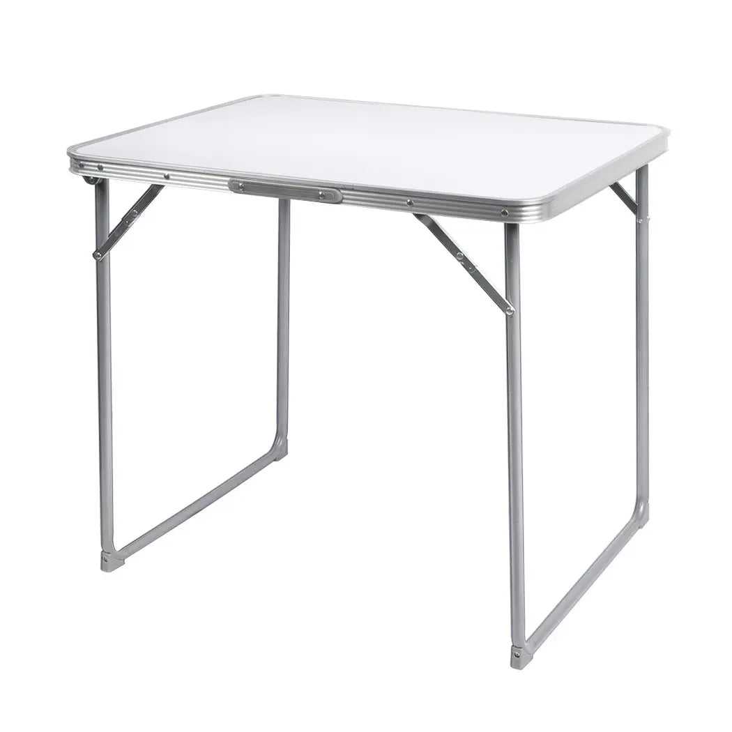 A lightweight and portable folding camping table made of aluminum, set up outdoors with a scenic background, perfect for picnics and camping.