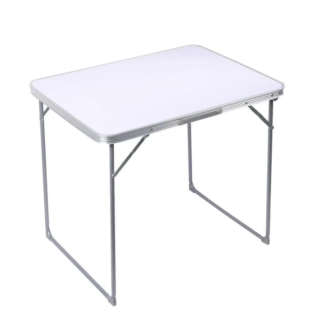A lightweight and portable folding camping table made of aluminum, set up outdoors with a scenic background, perfect for picnics and camping.
