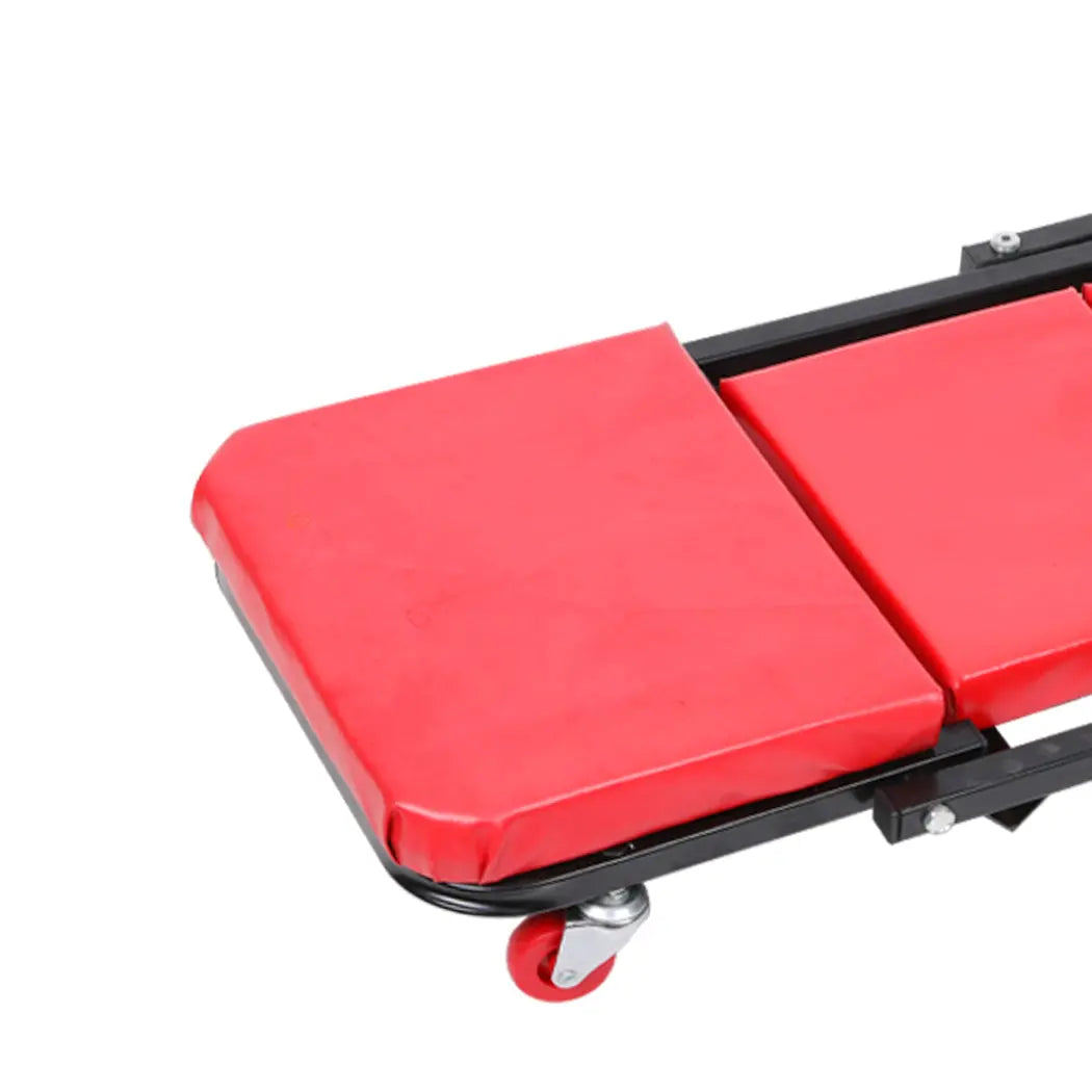 Folding Creeper Mechanic Stool with plush surface and ergonomic wheels, designed for garage repairs and maintenance tasks.