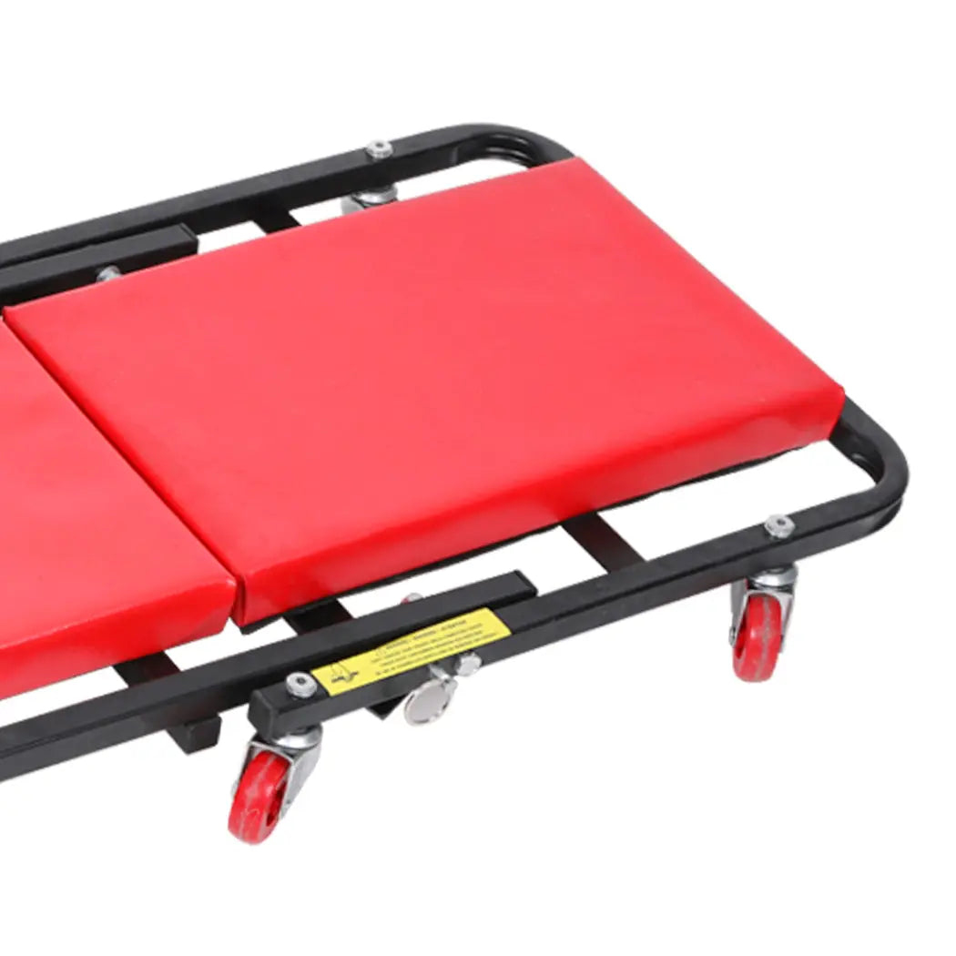 Folding Creeper Mechanic Stool with plush surface and ergonomic wheels, designed for garage repairs and maintenance tasks.