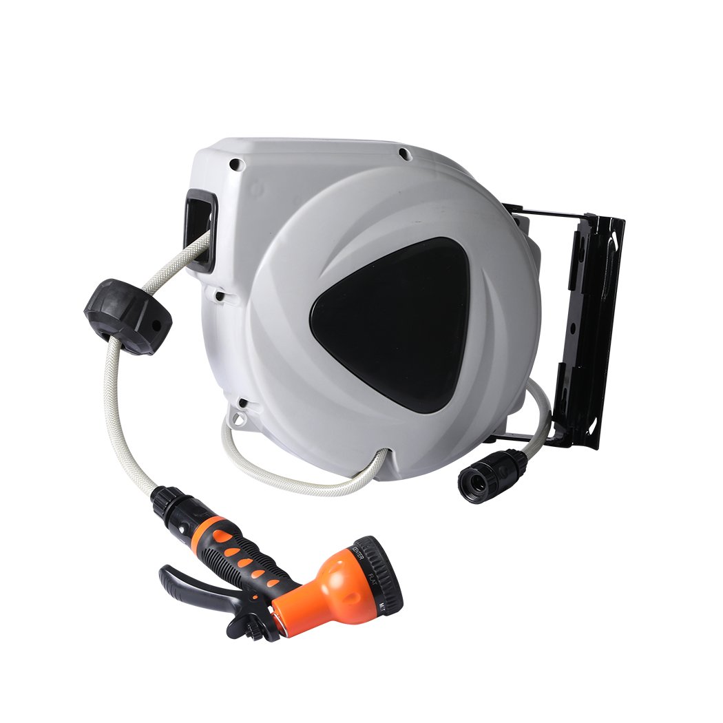 Retractable garden hose reel with spray gun nozzle mounted on a wall, showcasing its compact design and flexibility.