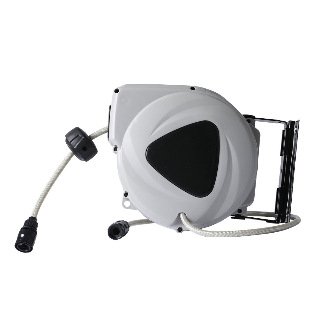 Retractable garden hose reel with spray gun nozzle mounted on a wall, showcasing its compact design and flexibility.