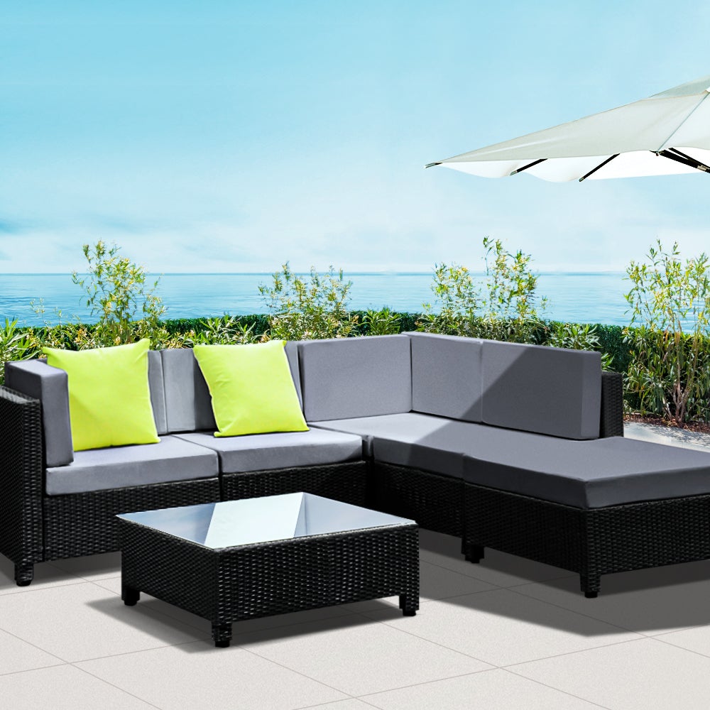 Gardeon 6pcs Outdoor Sofa Lounge Setting featuring modular design with grey cushions, black frame, and a glass-top coffee table, perfect for outdoor gatherings.
