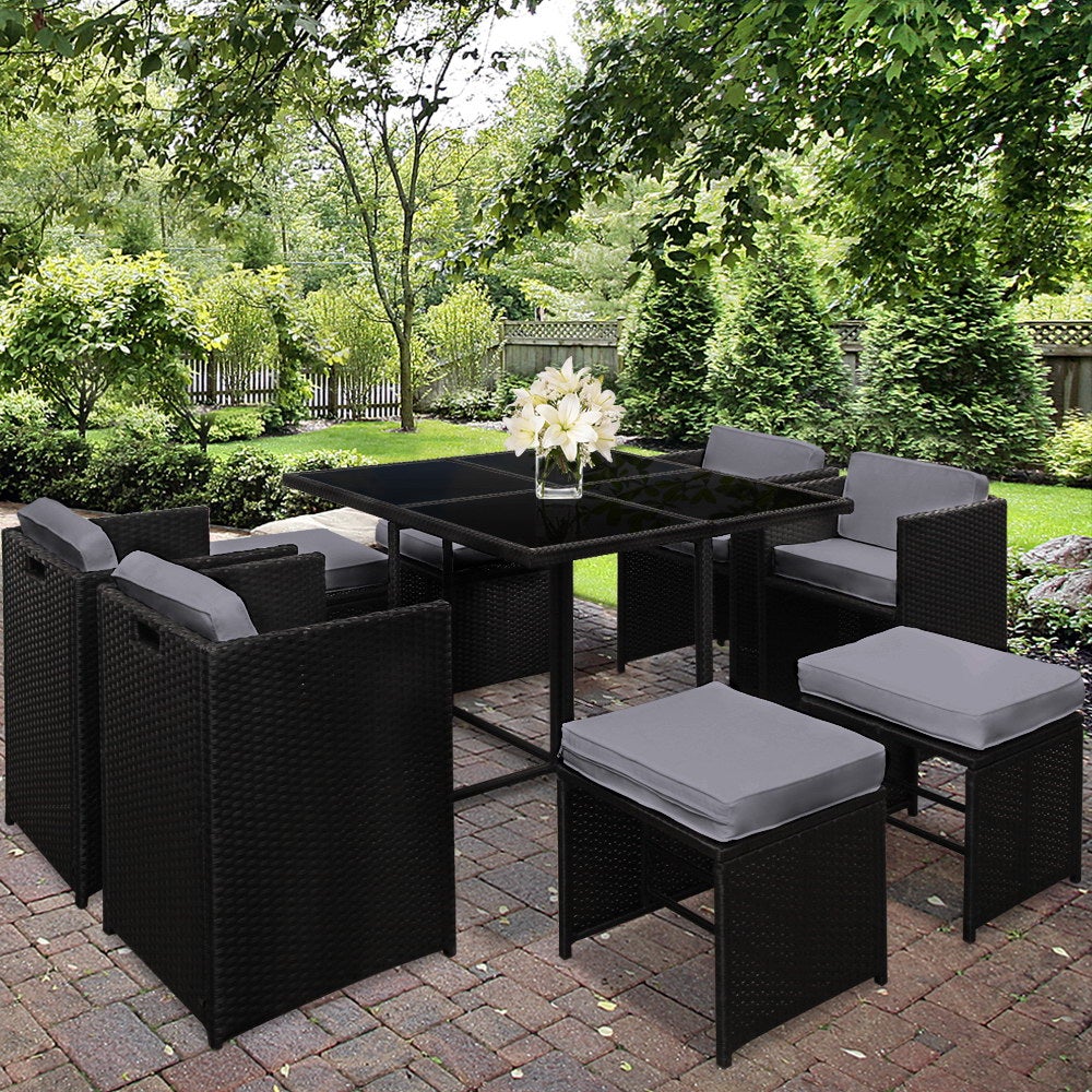 Gardeon 9 Piece Wicker Outdoor Dining Set featuring black and grey cushions, a glass top table, and stylish wicker design, perfect for outdoor dining.