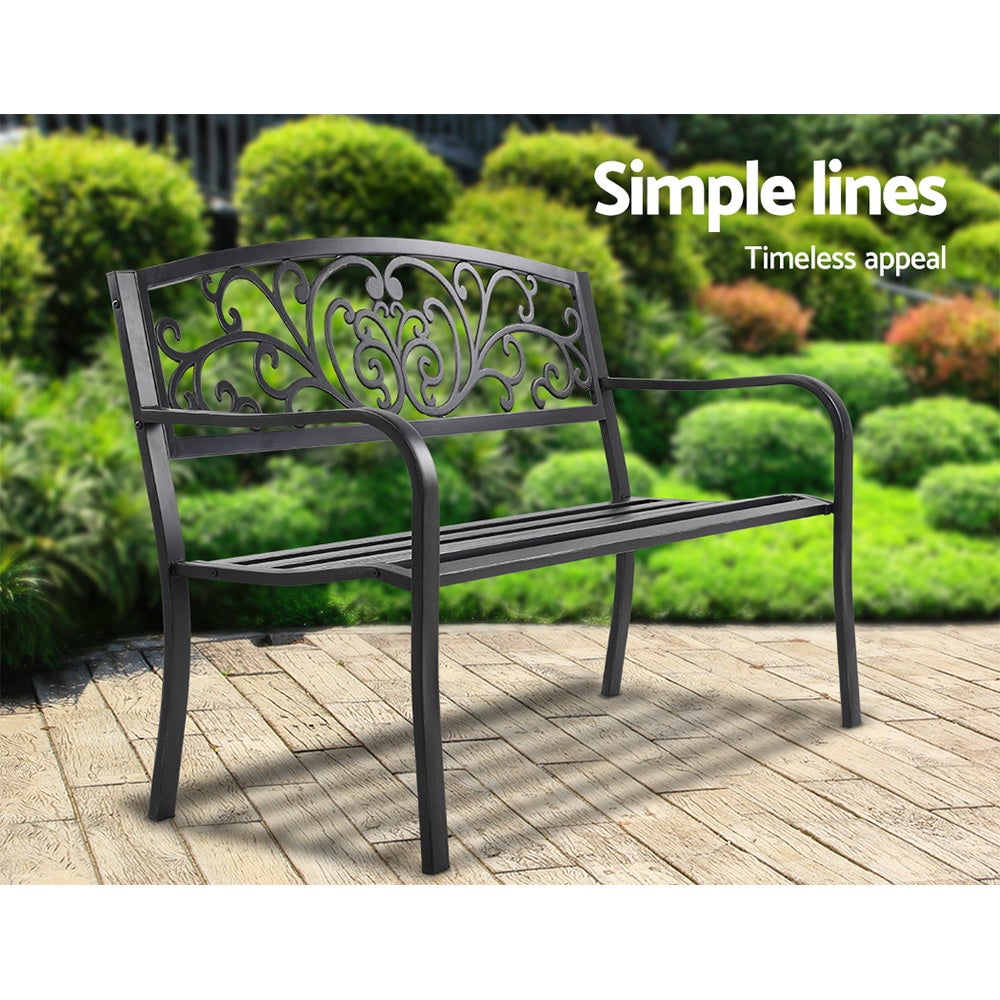 Gardeon Outdoor Garden Bench in Black with Victorian-inspired design and floral-patterned backrest, set in a garden.