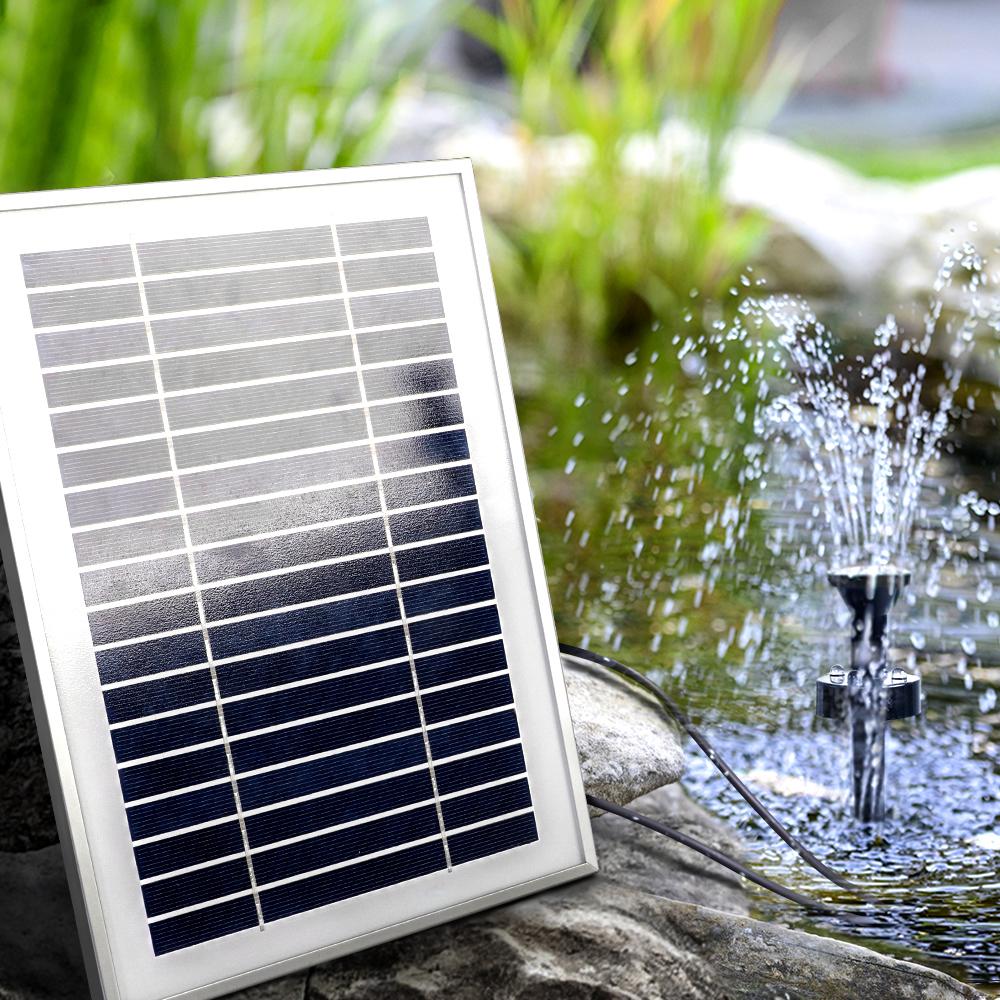Gardeon Solar Pond Pump with Battery Kit showcasing a beautiful garden fountain with water flowing and LED lights illuminating the scene.