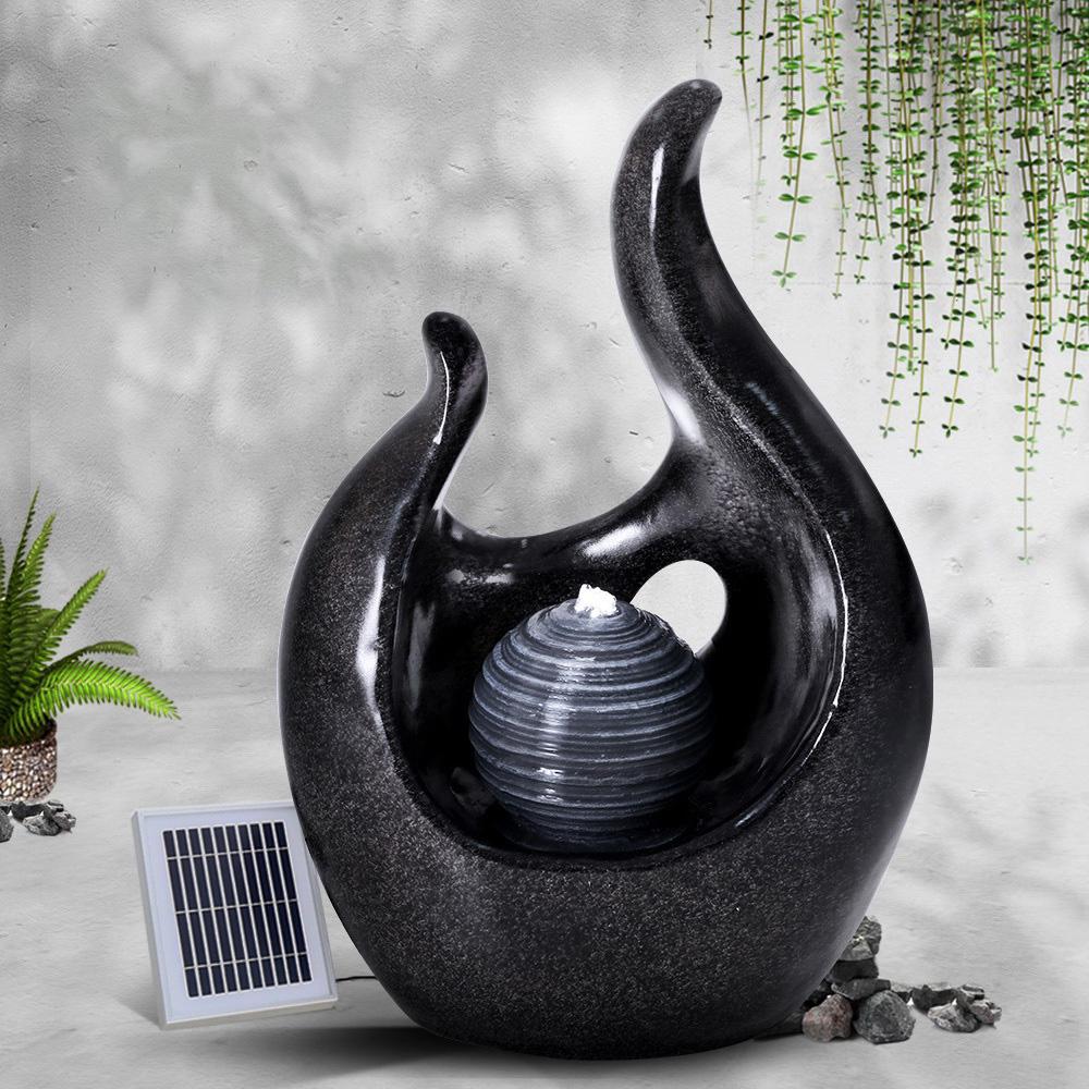 Gardeon Solar Water Fountain featuring a 3-tier design with cascading water and a pearl, set in a garden environment.