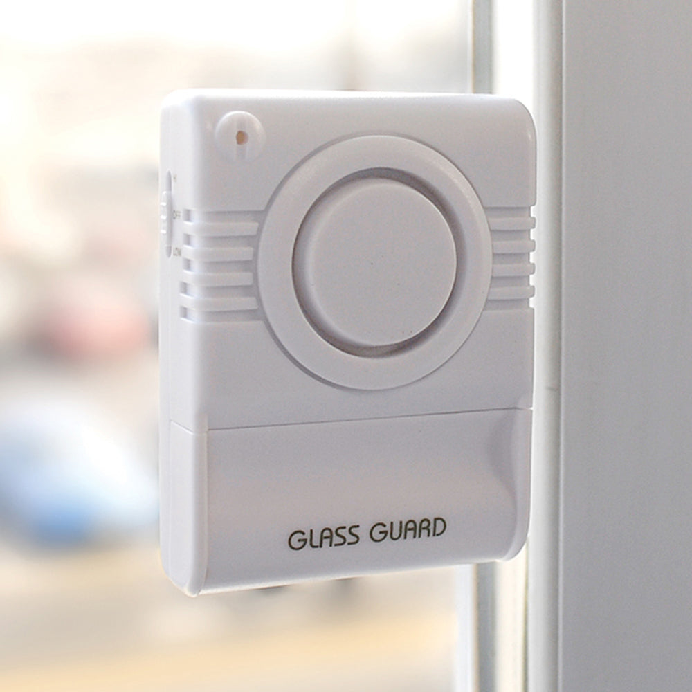 Glass Guard Alarm System installed on a window, featuring a sleek design and dual sensitivity switch for enhanced security.