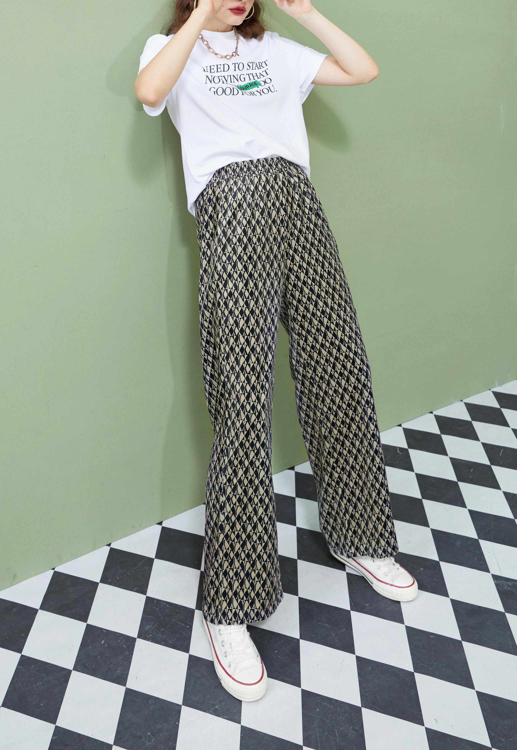 A pair of stylish graphic print high waist casual wide leg pants for women, showcasing a vintage design suitable for autumn wear.