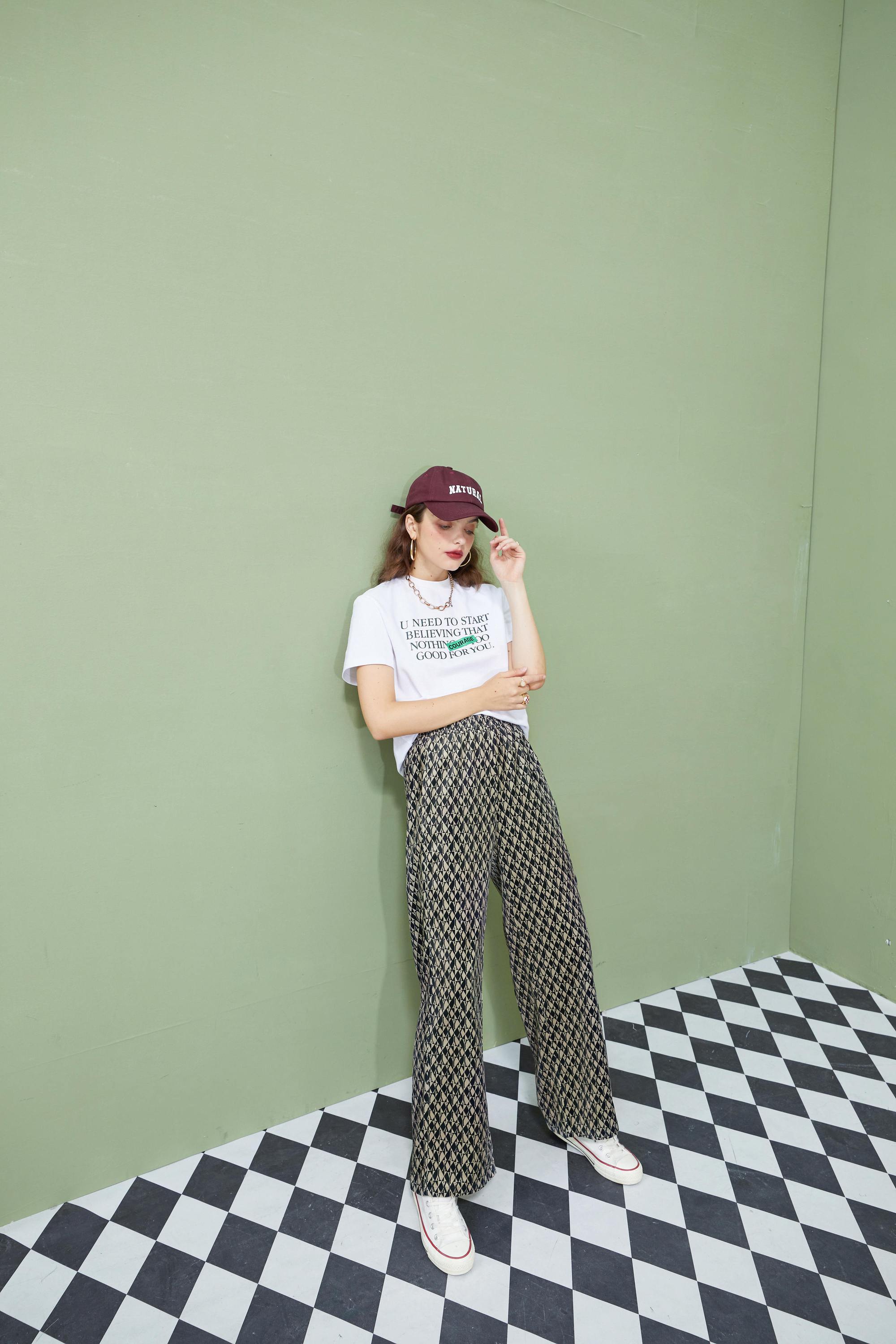 A pair of stylish graphic print high waist casual wide leg pants for women, showcasing a vintage design suitable for autumn wear.