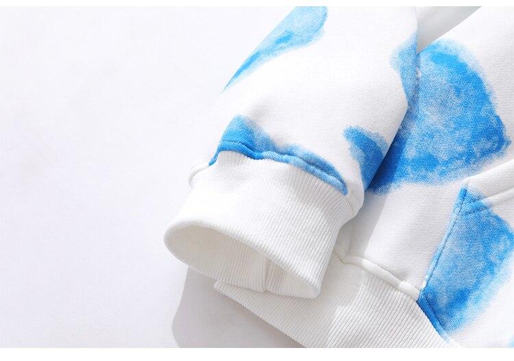 Men's hoodie featuring a heart inkjet print, big pocket, and soft velvet fabric in blue, pink, and yellow colors.