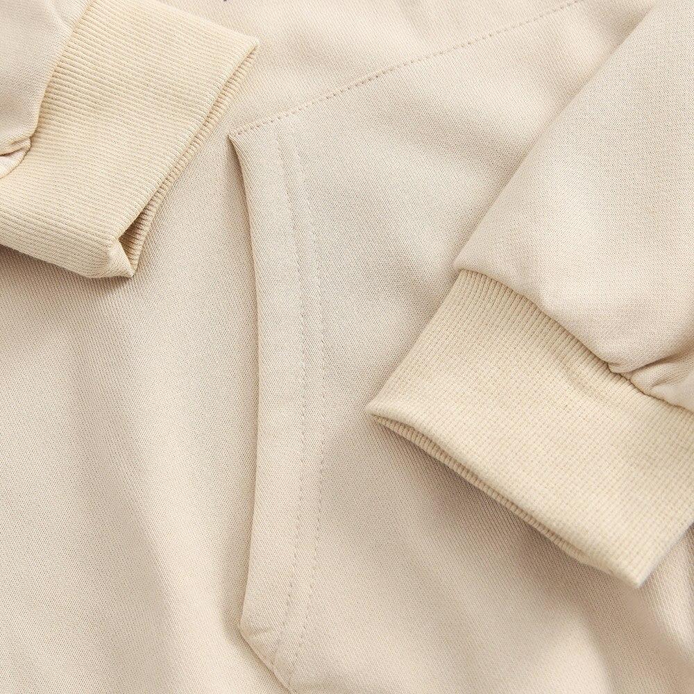 A stylish couple wearing a retro letter print patchwork color hoodie, showcasing a casual autumn streetwear look.