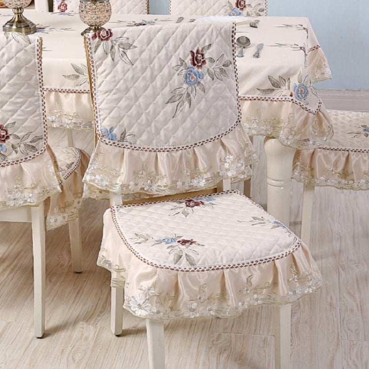 Elegant home dining table and chair non-slip cover with embroidered lace, enhancing dining aesthetics and functionality.