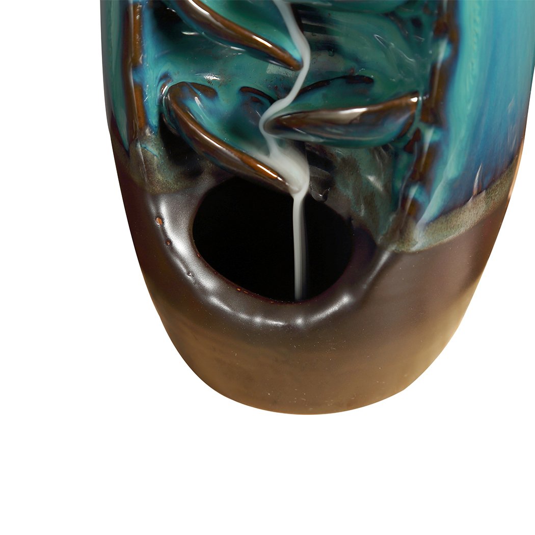 Ceramic incense burner designed like a mountain waterfall, featuring backflow smoke effect and natural incense cones.