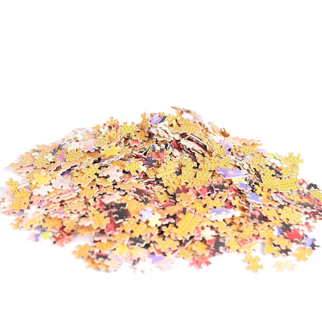 A colorful 1000-piece jigsaw puzzle made of basswood, showcasing a vibrant design with pieces scattered around, highlighting its glow-in-the-dark feature.