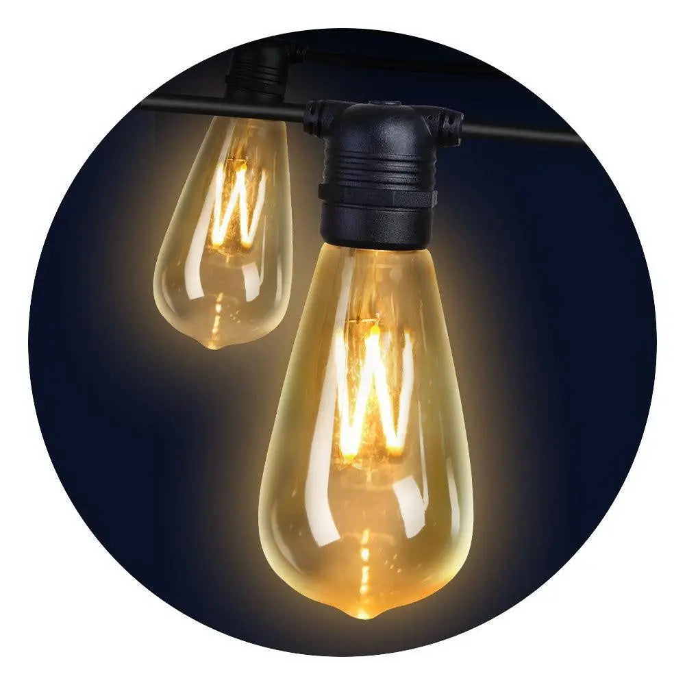 Jingle Jollys 80PCS LED Festoon String Lights displayed outdoors, illuminating a festive setting with a warm glow.