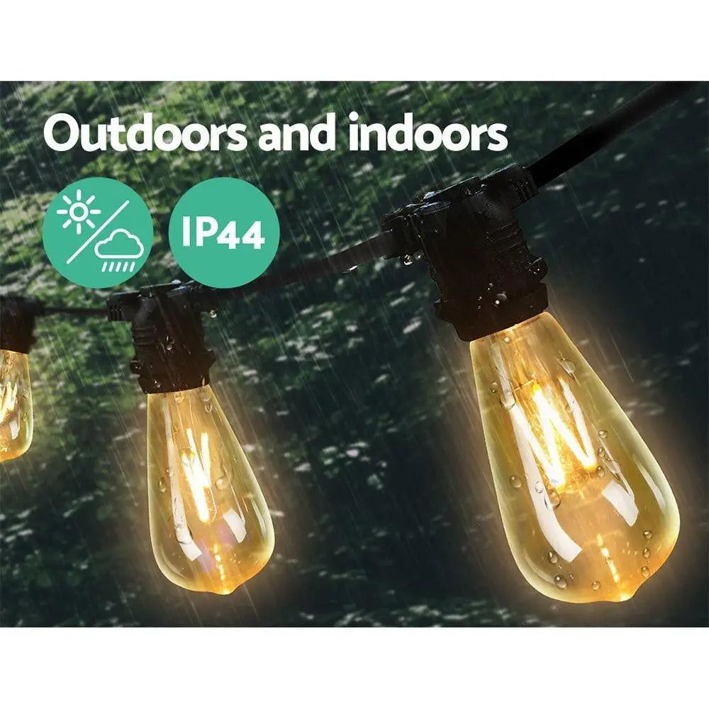 Jingle Jollys 80PCS LED Festoon String Lights displayed outdoors, illuminating a festive setting with a warm glow.