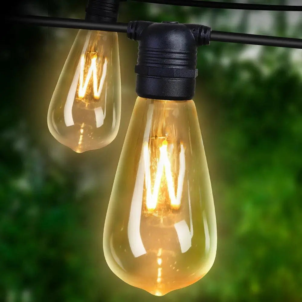 Jingle Jollys 80PCS LED Festoon String Lights displayed outdoors, illuminating a festive setting with a warm glow.