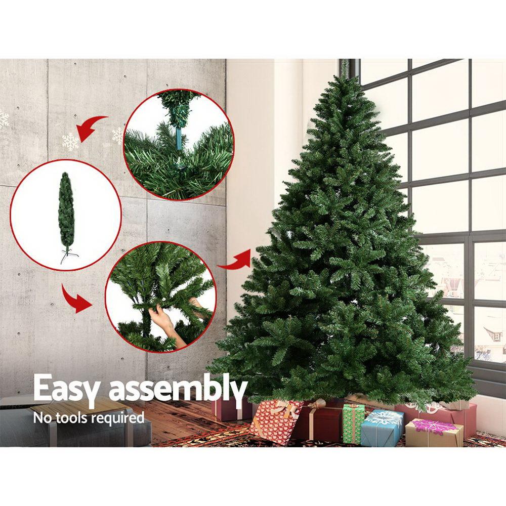 Jingle Jollys 8FT Green Christmas Tree with realistic PVC tips and sturdy metal stand, beautifully decorated for the holiday season.