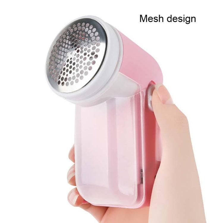 Hand holding a fabric shaver.