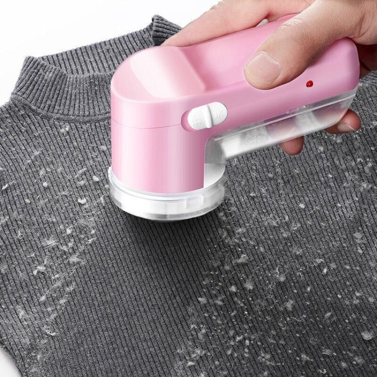 Electric fabric shaver on sweater.