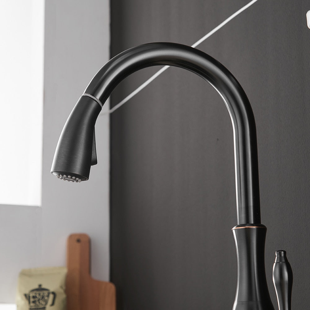 Black single handle pull out kitchen faucet with 360-degree swivel and brass construction, designed for modern kitchens.