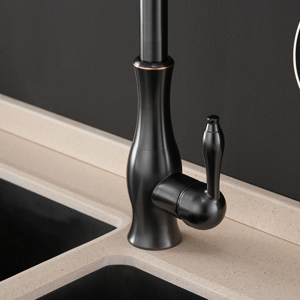 Black single handle pull out kitchen faucet with 360-degree swivel and brass construction, designed for modern kitchens.