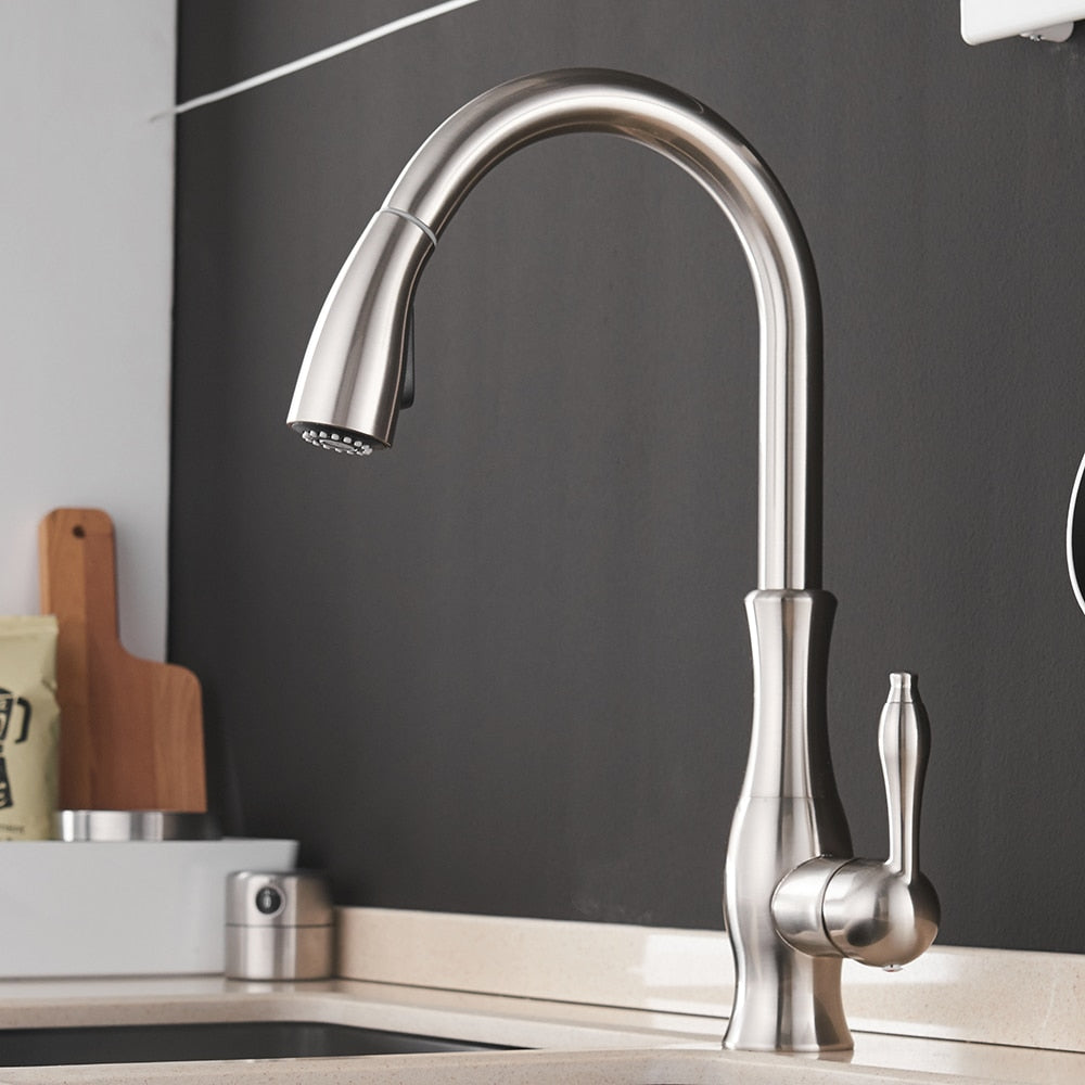 Black single handle pull out kitchen faucet with 360-degree swivel and brass construction, designed for modern kitchens.