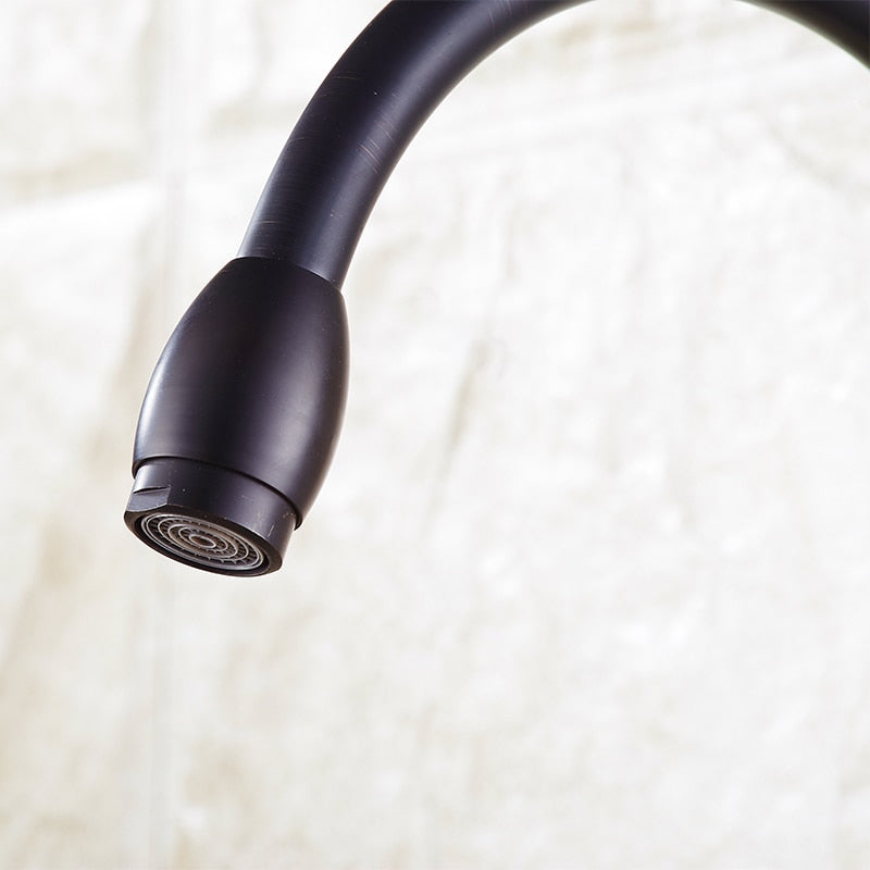 Stylish brass black bathroom faucet with a single handle and high spout, perfect for modern kitchens and bathrooms.