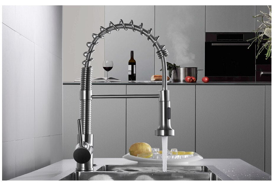 Brushed nickel kitchen faucet with pull-down spray head, showcasing a sleek and modern design suitable for any kitchen decor.