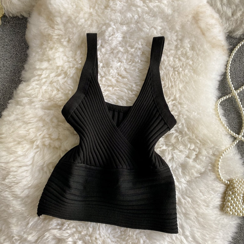 A stylish knitted crop top in solid color, showcasing its trendy design and soft texture, perfect for women's fashion.