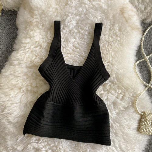 A stylish knitted crop top in solid color, showcasing its trendy design and soft texture, perfect for women's fashion.