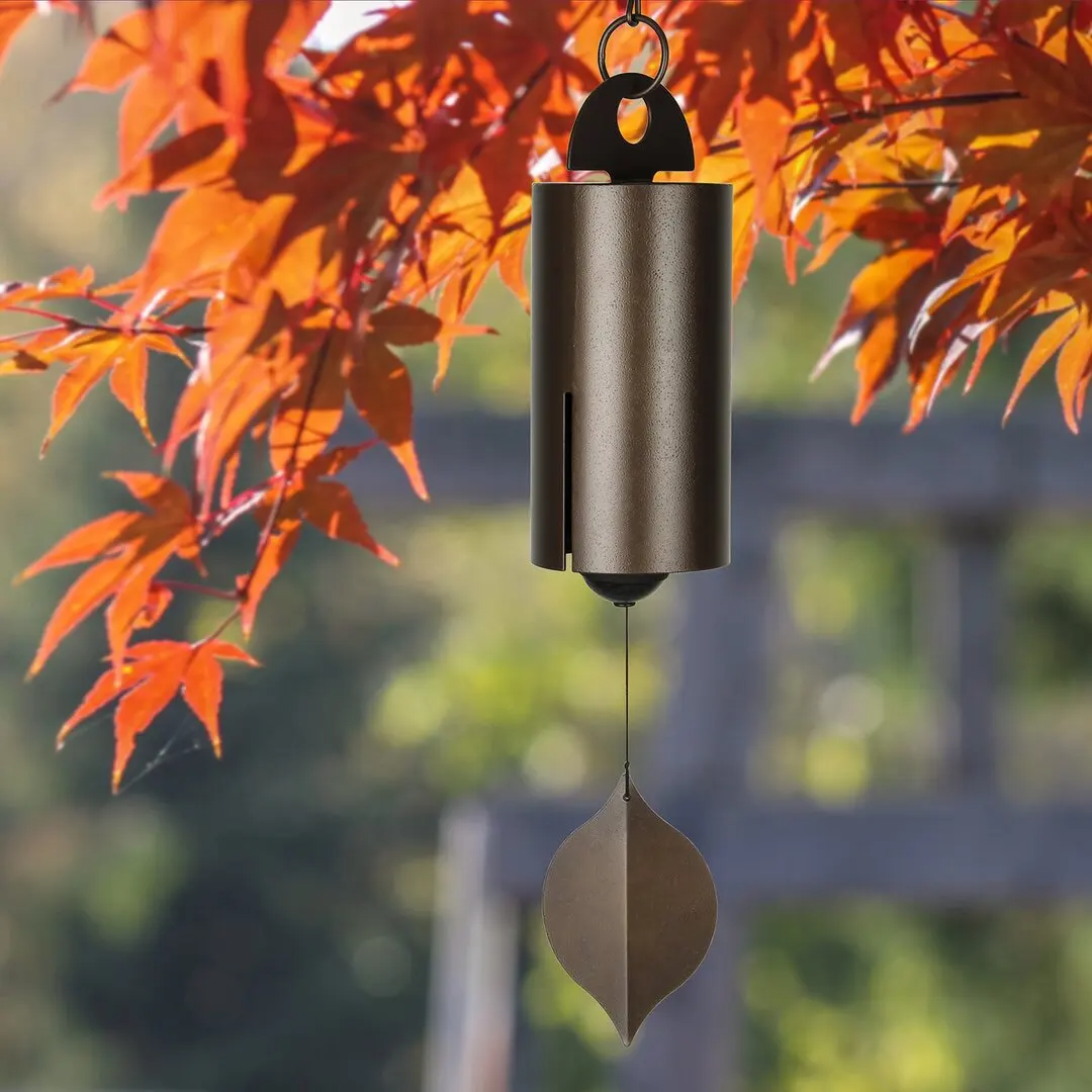 Large Deep Resonance Serenity Metal Bell Heroic Wind Chimes hanging outdoors, showcasing its antique copper finish and elegant design.