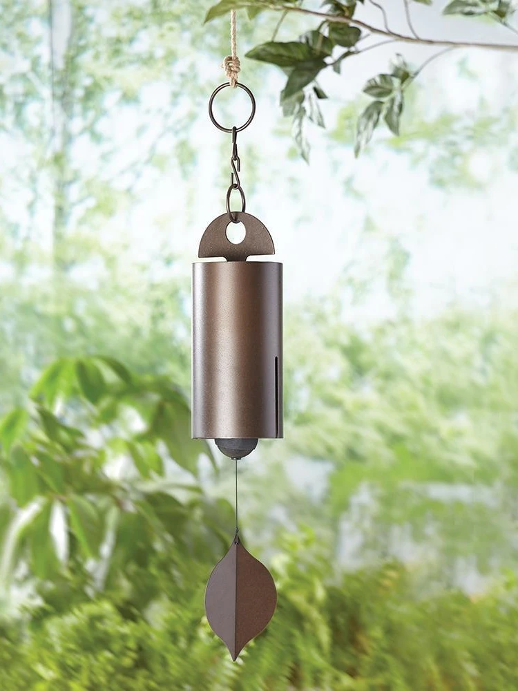 Large Deep Resonance Serenity Metal Bell Heroic Wind Chimes hanging outdoors, showcasing its antique copper finish and elegant design.