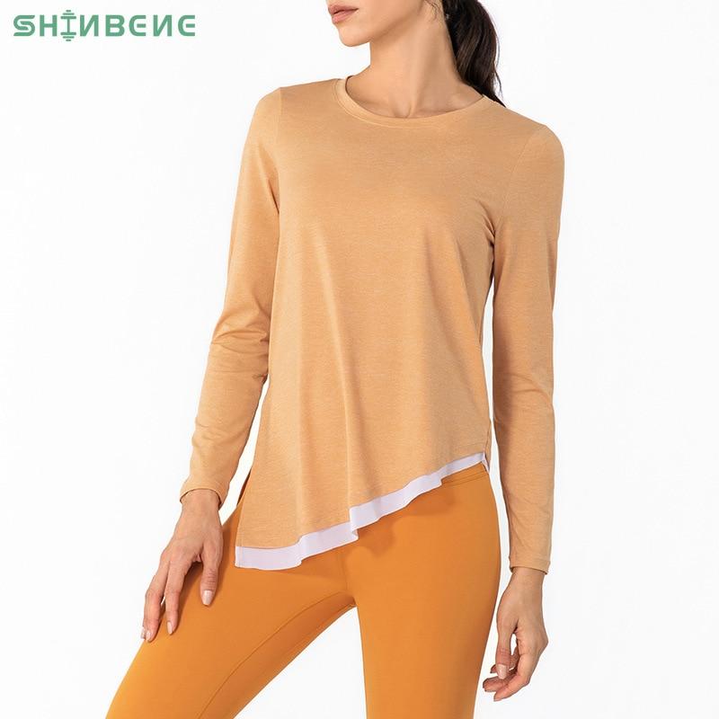 A stylish women's long sleeve fitness sport shirt featuring a side tie design, crew neck, and asymmetrical hem, perfect for yoga and workouts.